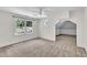 Carpeted bedroom featuring natural light from a large window and attic access at 5121 Ten Point Trl, Wake Forest, NC 27587