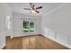 Formal dining room with beautiful hardwood floors, ceiling fan and large window at 5121 Ten Point Trl, Wake Forest, NC 27587