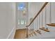 Elegant foyer featuring a staircase, chandelier, and front door with leaded glass at 5121 Ten Point Trl, Wake Forest, NC 27587