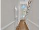 Hallway featuring hardwood floors, white trim, and a chandelier over the foyer at 5121 Ten Point Trl, Wake Forest, NC 27587