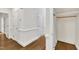 Hallway featuring hardwood floors, white trim, and closet storage space at 5121 Ten Point Trl, Wake Forest, NC 27587