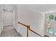 Bright hallway with carpet, a wooden banister, and a stylish chandelier lighting the front door at 5121 Ten Point Trl, Wake Forest, NC 27587