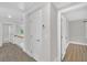 Bright hallway with carpet that leads to a bedroom with wood floors at 5121 Ten Point Trl, Wake Forest, NC 27587