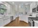 Bright, open kitchen with white cabinetry, stainless steel appliances, and natural light at 5121 Ten Point Trl, Wake Forest, NC 27587