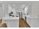 Spacious kitchen features white cabinets, stainless appliances, and a breakfast bar at 5121 Ten Point Trl, Wake Forest, NC 27587