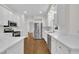 Modern kitchen featuring stainless steel appliances, white cabinets, and marble countertops at 5121 Ten Point Trl, Wake Forest, NC 27587