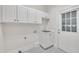 Laundry Room featuring storage cabinets, marble floors, and a utility sink at 5121 Ten Point Trl, Wake Forest, NC 27587