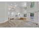 Open-concept living space with high ceilings, natural light, and a view to kitchen at 5121 Ten Point Trl, Wake Forest, NC 27587