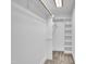 Well-organized walk-in closet with shelving and carpeted floor at 5121 Ten Point Trl, Wake Forest, NC 27587