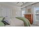 Cozy bedroom featuring a tray ceiling, a ceiling fan, and natural light from the windows at 518 Toran Dr, Wake Forest, NC 27587
