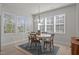 Bright dining room featuring an oval table with seating under a modern chandelier with natural light at 518 Toran Dr, Wake Forest, NC 27587