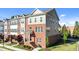 Exterior view of a brick townhome with well-maintained landscaping at 518 Toran Dr, Wake Forest, NC 27587