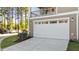 Exterior view of the garage door with an upper level deck and cars parked on the driveway at 518 Toran Dr, Wake Forest, NC 27587