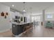 Well-lit open kitchen with a large central island featuring modern appliances and eat-in dining area at 518 Toran Dr, Wake Forest, NC 27587