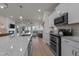 Open-concept kitchen with stainless appliances and island flowing into a well-lit living space at 518 Toran Dr, Wake Forest, NC 27587