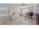 Stylish living room with piano, hardwood floors, and large windows for abundant natural light at 518 Toran Dr, Wake Forest, NC 27587