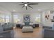 Bright living room featuring hardwood floors, modern ceiling fan, and comfortable seating arrangements at 518 Toran Dr, Wake Forest, NC 27587