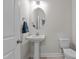 Well-lit powder room with pedestal sink, oval mirror, and neutral paint at 518 Toran Dr, Wake Forest, NC 27587