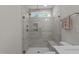 Modern tiled shower with glass door and window providing natural light, accompanied by a built-in bench at 518 Toran Dr, Wake Forest, NC 27587