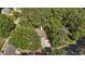 An aerial view shows mature trees surrounding the home, providing shade, and a long driveway at 5301 Northpines Dr, Raleigh, NC 27610