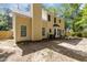 View of the backyard featuring the yellow home with black door and patio area at 5301 Northpines Dr, Raleigh, NC 27610