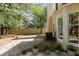View of the fenced backyard and side of the yellow house with an air conditioning unit at 5301 Northpines Dr, Raleigh, NC 27610