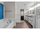 Spacious bathroom with a soaking tub, walk-in closet, and double vanity at 5301 Northpines Dr, Raleigh, NC 27610