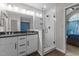 Bright bathroom featuring a double vanity, granite countertops, and a glass-enclosed shower at 5301 Northpines Dr, Raleigh, NC 27610