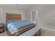 Cozy bedroom with a rustic wooden bed frame and a view of the bathroom at 5301 Northpines Dr, Raleigh, NC 27610