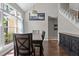 Dining room with hardwood floors, large windows, and access to the staircase at 5301 Northpines Dr, Raleigh, NC 27610