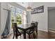 Inviting dining room with hardwood floors and a large window offering natural light at 5301 Northpines Dr, Raleigh, NC 27610