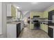 This well-lit kitchen showcases updated cabinets and stainless steel appliances at 5301 Northpines Dr, Raleigh, NC 27610