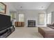 Bright living room featuring neutral walls, fireplace, and large windows that offer plenty of natural light at 5301 Northpines Dr, Raleigh, NC 27610