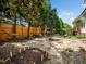 Spacious backyard featuring a fire pit, privacy fence, hammock, and mature trees at 5708 Big Sandy Dr, Raleigh, NC 27616