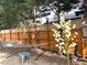 Serene backyard featuring a hammock, blooming yucca plant, and a wooden fence for privacy at 5708 Big Sandy Dr, Raleigh, NC 27616