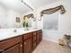 Bathroom with double sink vanity, neutral colored walls, and large decorative mirror at 5708 Big Sandy Dr, Raleigh, NC 27616