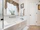 This bright bathroom offers a soaking tub with a window, providing a relaxing and spa-like atmosphere at 5708 Big Sandy Dr, Raleigh, NC 27616