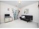 A bonus room with futon sofa and bamboo plants in front of a window at 5708 Big Sandy Dr, Raleigh, NC 27616