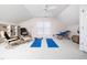 Bonus room with yoga mats, ceiling fan, built-in shelving, and vaulted ceilings at 5708 Big Sandy Dr, Raleigh, NC 27616