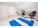 Bright bonus room featuring yoga mats, a ceiling fan, and custom built-in shelving at 5708 Big Sandy Dr, Raleigh, NC 27616