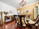 Chic dining room features a modern light fixture, glass table, and mirrored accent wall at 5708 Big Sandy Dr, Raleigh, NC 27616