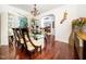 Elegant dining area with a glass-top table, stylish seating, and views to a display cabinet at 5708 Big Sandy Dr, Raleigh, NC 27616