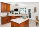 Updated kitchen with a center island, modern appliances, and an open view to the living area at 5708 Big Sandy Dr, Raleigh, NC 27616