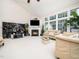 Bright living room featuring a fireplace, large windows, and neutral decor at 5708 Big Sandy Dr, Raleigh, NC 27616