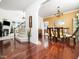 Open-concept living area showcasing hardwood floors, staircase, and seamless flow into the dining area at 5708 Big Sandy Dr, Raleigh, NC 27616