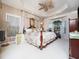 Luxurious main bedroom with a tray ceiling, chandelier, and a cozy seating area at 5708 Big Sandy Dr, Raleigh, NC 27616
