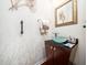 Stylish half bathroom featuring a vessel sink, designer mirror, and decorative wall accents at 5708 Big Sandy Dr, Raleigh, NC 27616