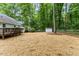 View of the spacious backyard with deck, storage shed, and perimeter fence at 702 Sanderson Dr, Durham, NC 27704