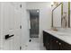 Stylish bathroom with white cabinets, stone counters, and a view of the glass enclosed shower at 702 Sanderson Dr, Durham, NC 27704