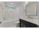 Bathroom has gold fixtures, patterned tile floor, and modern shower and tub at 702 Sanderson Dr, Durham, NC 27704